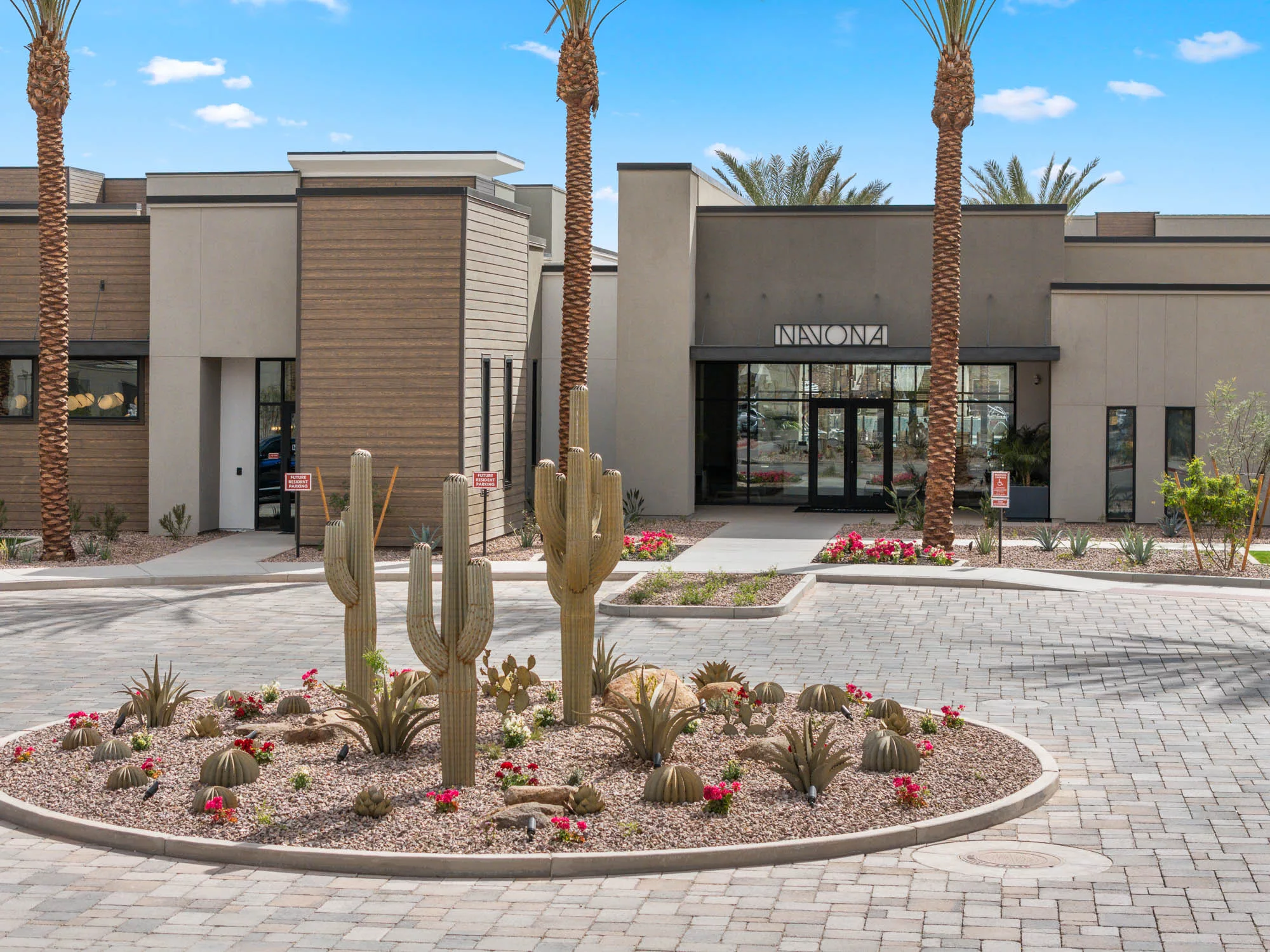 Navona Leasing Office with a roundabout with steel saguaro cacti.